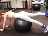 Candice Swanepoel doing stretches on a stability ball