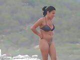 Beautiful bottomless milf on the beach